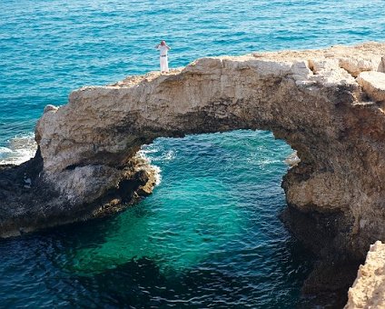 _DSC0041 Markos standing on the natural bridge, over the clear waters at the sea caves area.