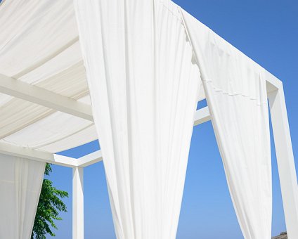 _DSC0020 At the loungers at Capo Bay Hotel . The clear blue waters of the Mediterranean at Fig Tree Bay in the background.