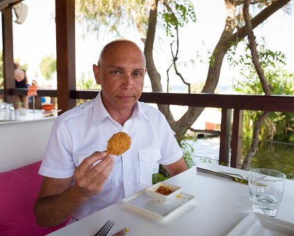 _DSC0020-2 Markos eating a breaded shrips at Koi of Capo Bay Hotel .