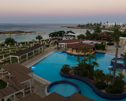 _DSC0237 Evening view of the pool area and Fig Tree Bay from the balcony of the hotel room at Capo Bay hotel.
